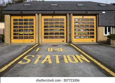 Front View Of A Fire Station With Fire-engines Inside