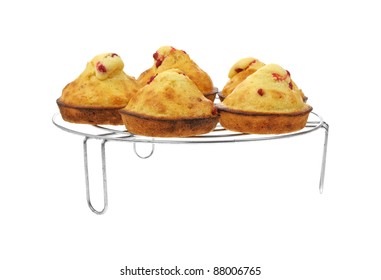 A front view of five fresh baked muffins on cooling rack.