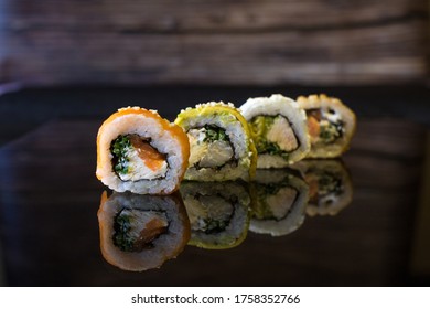 Front View Of Four Pieces Of Sushi, On A Black Glass Base