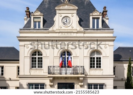 Front view of a french city hall with french and european flags and the national motto of France 