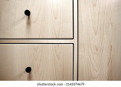 Front view of fully inset maple cabinet drawers and door
