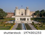 Front view with garden and marble pavilion of white Alamgiri gate built by mughal emperor Aurangzeb as entrance to Lahore fort, a UNESCO World Heritage site, Punjab, Pakistan