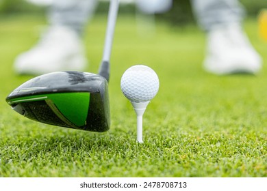 Front view of golf ball on tee with golf drivers at golf course. - Powered by Shutterstock