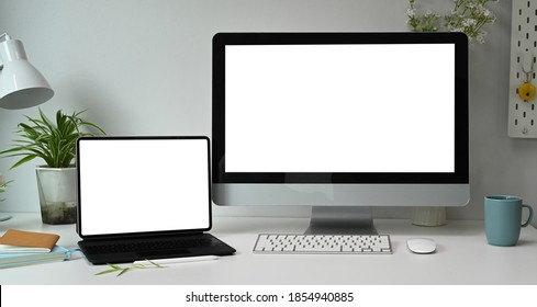 Front View Of Graphic Designer Artist Workplace With Multiple Computer Screens In Modern Office.