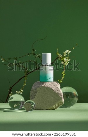 Front view of gray stones, transparent ball. Mock up of cosmetic package.