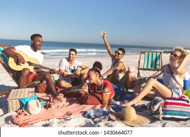 Front view of group of happy diverse friends having fun together on the beach - Powered by Shutterstock