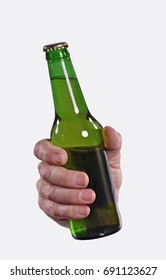 Front View From A Hand Hold A Green Beer Bottle Isolated On White Background.