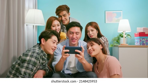 Front View Of Happy Asian Friends Smile Watch Man Using Phone Playing Game - Horizontal Landscape Mobile