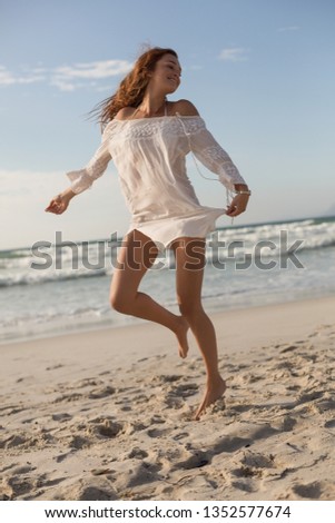 Similar – Young, slim woman on the beach of the Baltic Sea in summer wind