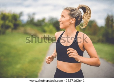 Similar – Fit healthy athletic woman jogging on a river bank