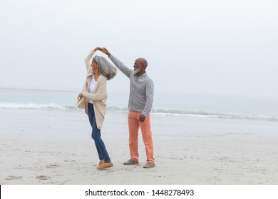 Front View Of Happy Senior Diverse Couple Smiling At The Beach. Authentic Senior Retired Life Concept