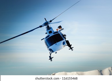 Front view of helicopter in flight. Fly over the snow mountain.