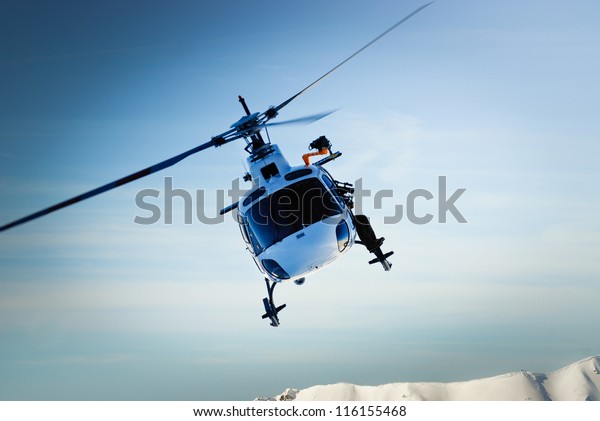 Front view of helicopter in flight. Fly over\
the snow mountain.