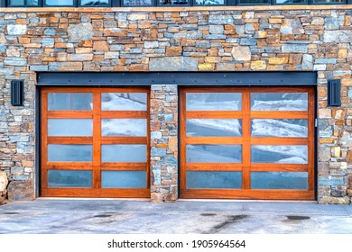 Front View Of Home Garage With Two Frosted Glass Doors And Stone Brick Wall