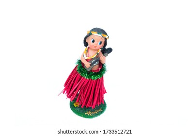 Front View Of A Hula Girl Doll With Ukulele On The White Background.
