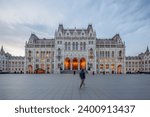 The front view of the Hungarian Parliament Building at Kossuth Lajos Square at twilight in Budapest, Hungary