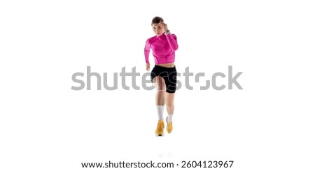 Front view image of concentrated young woman in sportswear, runner in motion, competing, training isolated on white studio background. Concept of athletics, sport, endurance, healthy lifestyle. Ad