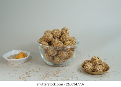 Front View Of Indian Sweet Til Ladoo In Transparent Bowl With White Background