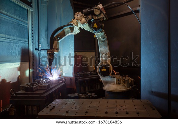 front
view, inside the factory, robotic machine
welding