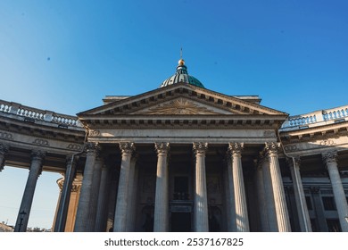 Front view of Kazan Cathedrals neoclassical facade and dome in St. Petersburg, Russia, against a blue sky, showcasing its architectural grandeur and historic significance. No people are visible - Powered by Shutterstock