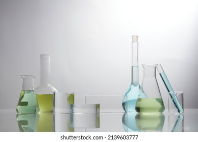 Front view of laboratory equipment filled with colorful fluid in a beaker test tube in lab background for experiment advertising  - Shutterstock ID 2139603777