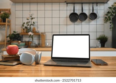 Front view laptop with blank screen on a wooden kitchen counter - Powered by Shutterstock