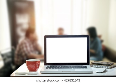 Front View Of The Laptop And Coffee Cup Is On The Work Table In Meeting Room.
