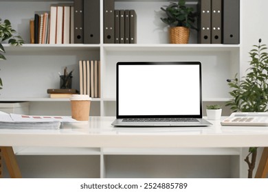 Front view laptop with empty display on a desk in front of a bookshelf