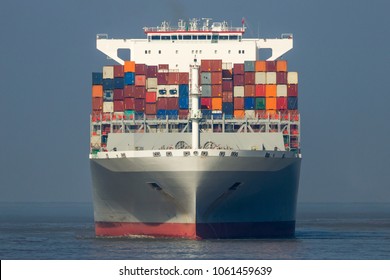 Front View Of A Large Shipping Container Ship In The Ocean.