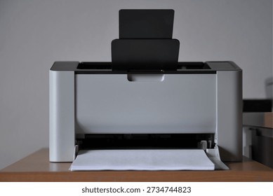 Front view of laser printer against white wall