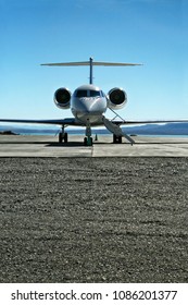 Front View Of A Lear Jet On A Tarmac Ready To Fly With Passengers.