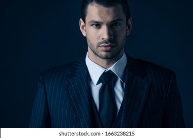 Front View Of Mafioso Looking At Camera On Dark Blue