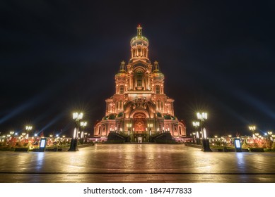 Front View From Of The Main Cathedral Of The Russian Armed Forces In Honor Of The Resurrection Of Christ With Bell Tower At Patriot Theme Park In Kubinka Illuminated In Gold Color In The Dusk.