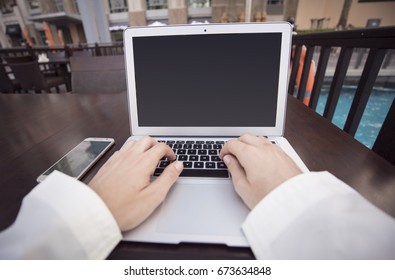 Front View Of Male Hands Typing On Laptop Keyboard