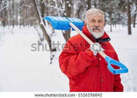 Similar – Image, Stock Photo A man clears snow from a street with a snow shovel