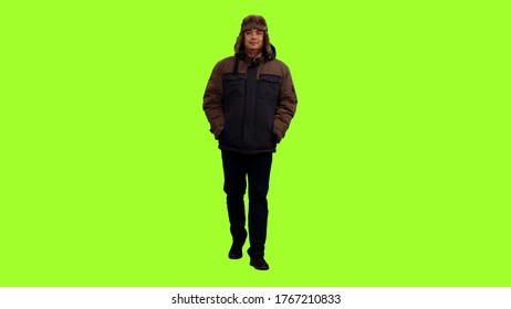 Front View Of A Man In Winter Clothes Walks On Green Screen Background