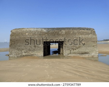 Front view of a massive concrete German bunker on the Atlantic coast
