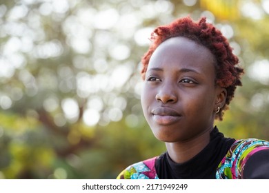 Front View Of A Melancholy Young African Teenager In Love, Dreaming About Her Favorite Movie Star