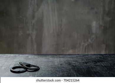 front view of metal handcuffs on table in the interrogation room 