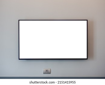 Front View Of Mockup White Blank Space On TV Screen On The Wall Near The Plug And Empty Shelf In The Hotel Bedroom.