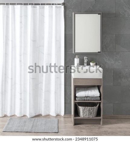Front view of a modern bathroom interior with a mirror, towels, and a marble shower curtain. Minimal-style white bathroom vanity, with a grey color porcelain floor tiles background