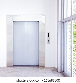 Front View Of A Modern Elevator With Closed Doors In Lobby