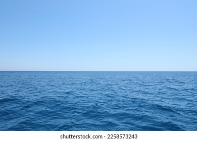 The front view in the morning sky is bright blue with clear white clouds. And the ocean deep indigo in daylight. Feeling calm cool relaxing. The idea for cold background and copy space on the top - Shutterstock ID 2258573243
