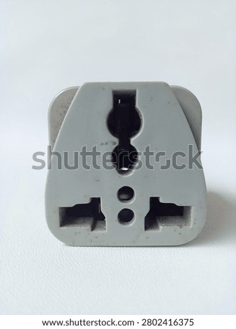 Front view of multi slot universal power adapter receptacle on white background