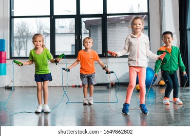 Front View Of Multiethnic Children Doing Exercise With Jump Rope In Gym