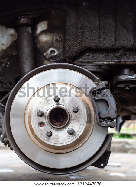 front view\
of new brake disc on old vehicle close\
up