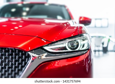 front view of new modern red car led headlight in showroom
