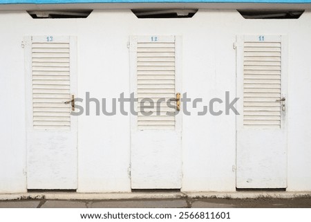 Front view of old beach cabins with numbers on it