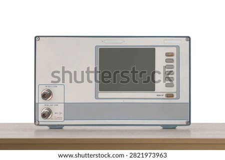 front view old electronic RF (Radio Frequency) signal testing and measuring device resting on a wooden floor, white wall background, object, decor, technology, collection, copy space
