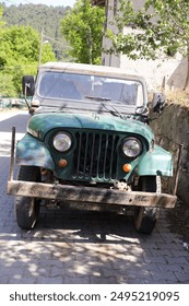 Front view of old and rusty abandoned military jeep